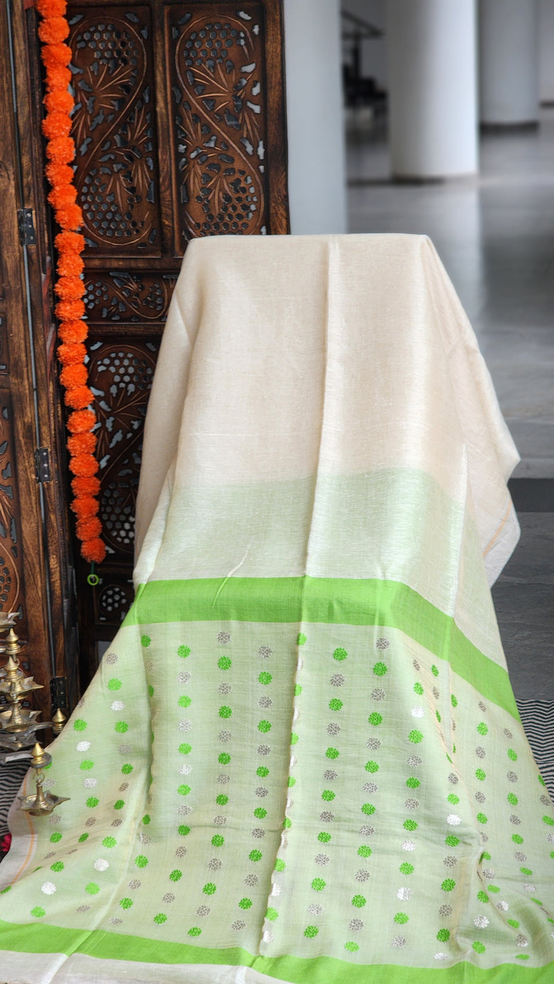 Ivory silk linen saree with parrot-green border and zari butis handwoven in Bengal by RURIethnic
