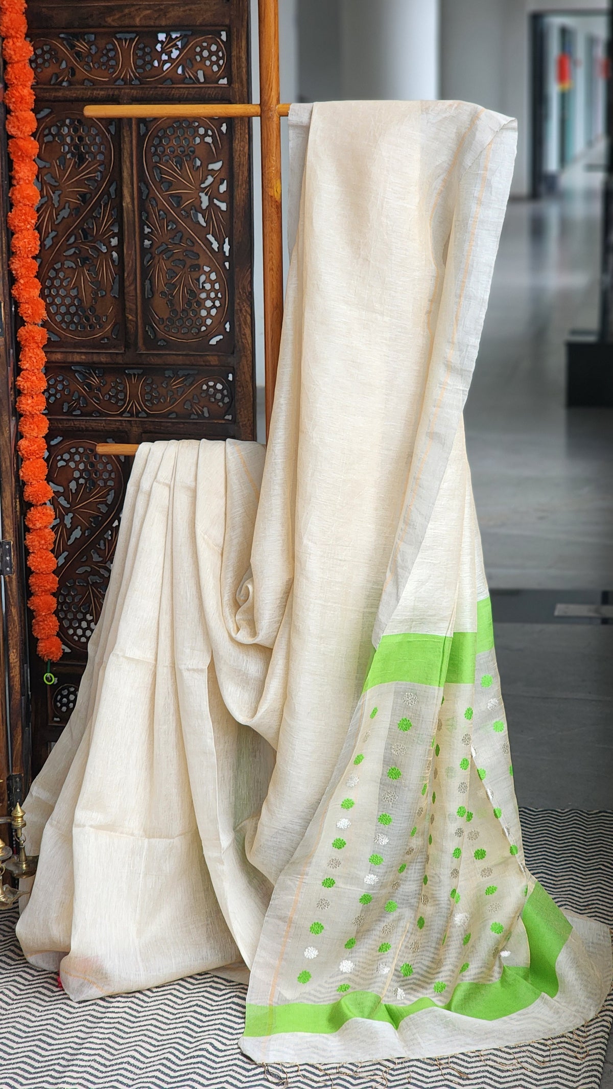 Ivory silk linen saree with parrot-green border and zari butis handwoven in Bengal by RURIethnic
