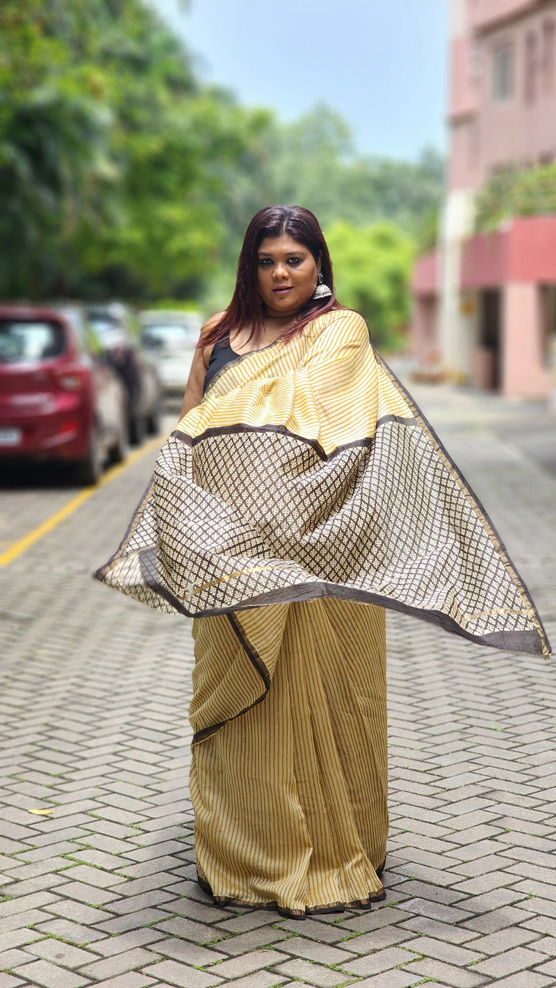 Yellow silk–cotton saree with black Bagru handblock stripes, handcrafted and bold, perfect for everyday elegance.