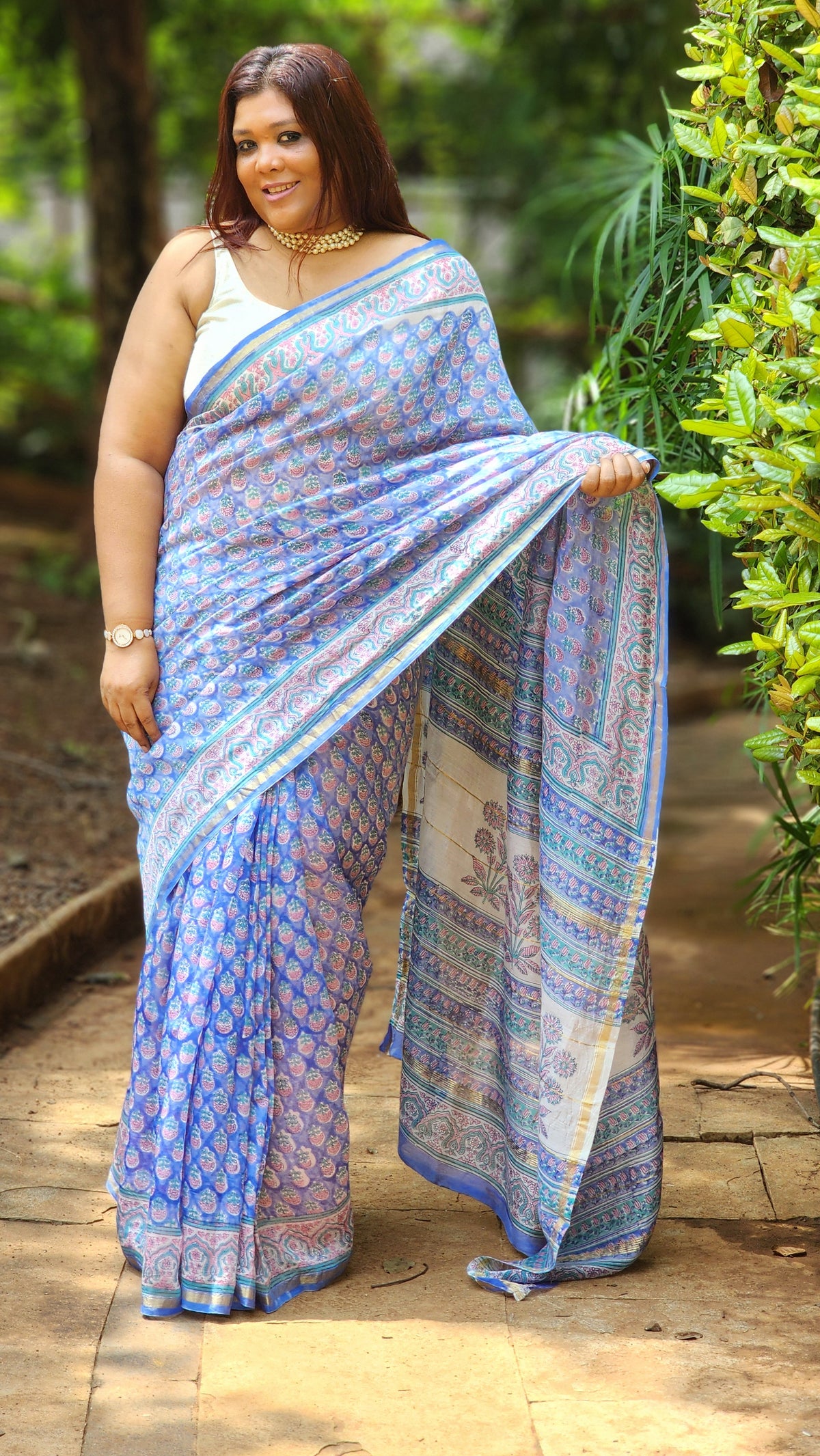 Blue Chanderi silk cotton saree with white Bagru handblock floral motifs and zari border, lightweight and handcrafted.