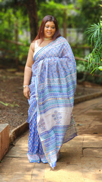 Blue Chanderi silk cotton saree with white Bagru handblock floral motifs and zari border, lightweight and handcrafted.