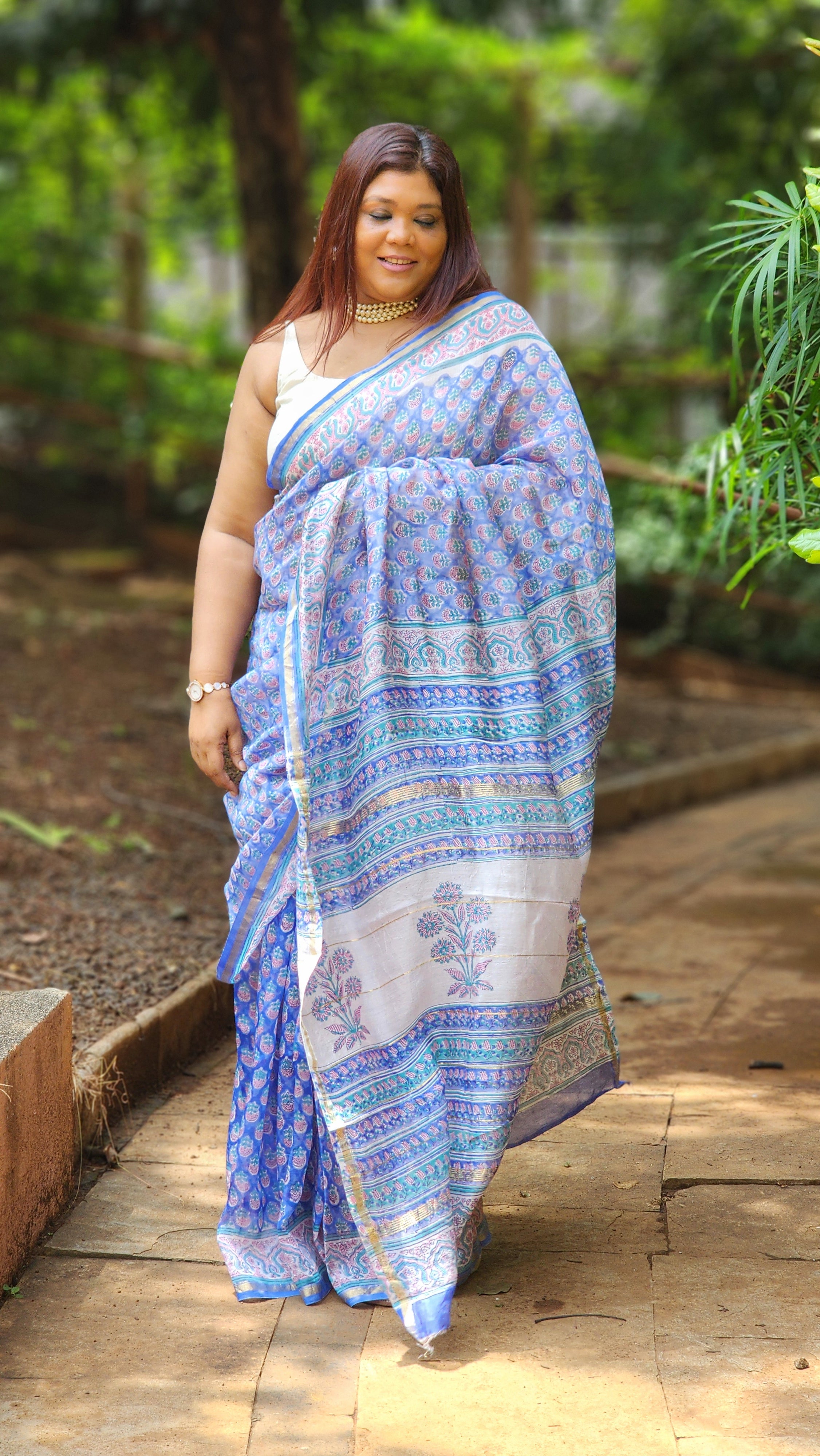 Blue Chanderi silk cotton saree with white Bagru handblock floral motifs and zari border, lightweight and handcrafted.