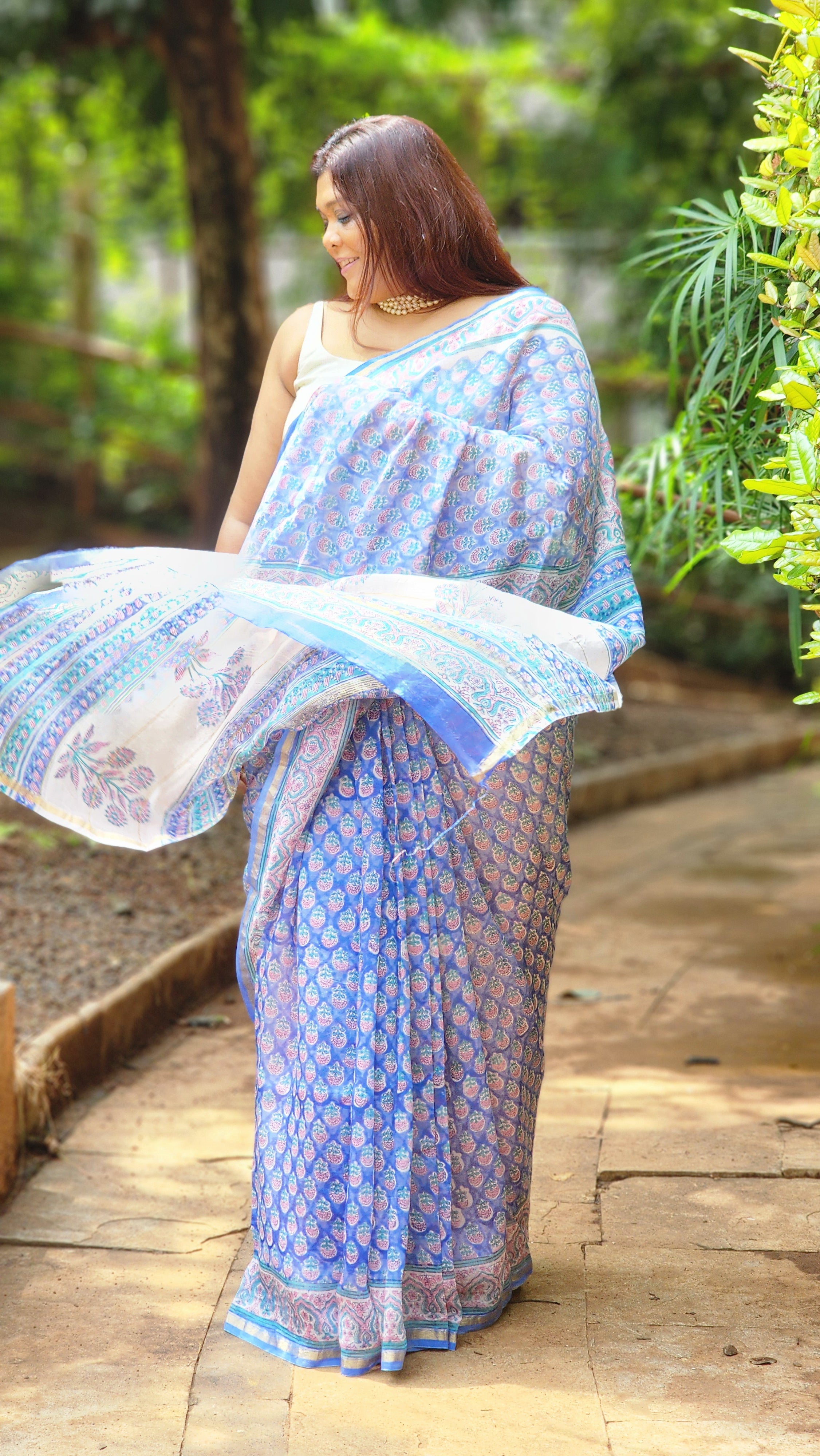 Blue Chanderi silk cotton saree with white Bagru handblock floral motifs and zari border, lightweight and handcrafted.