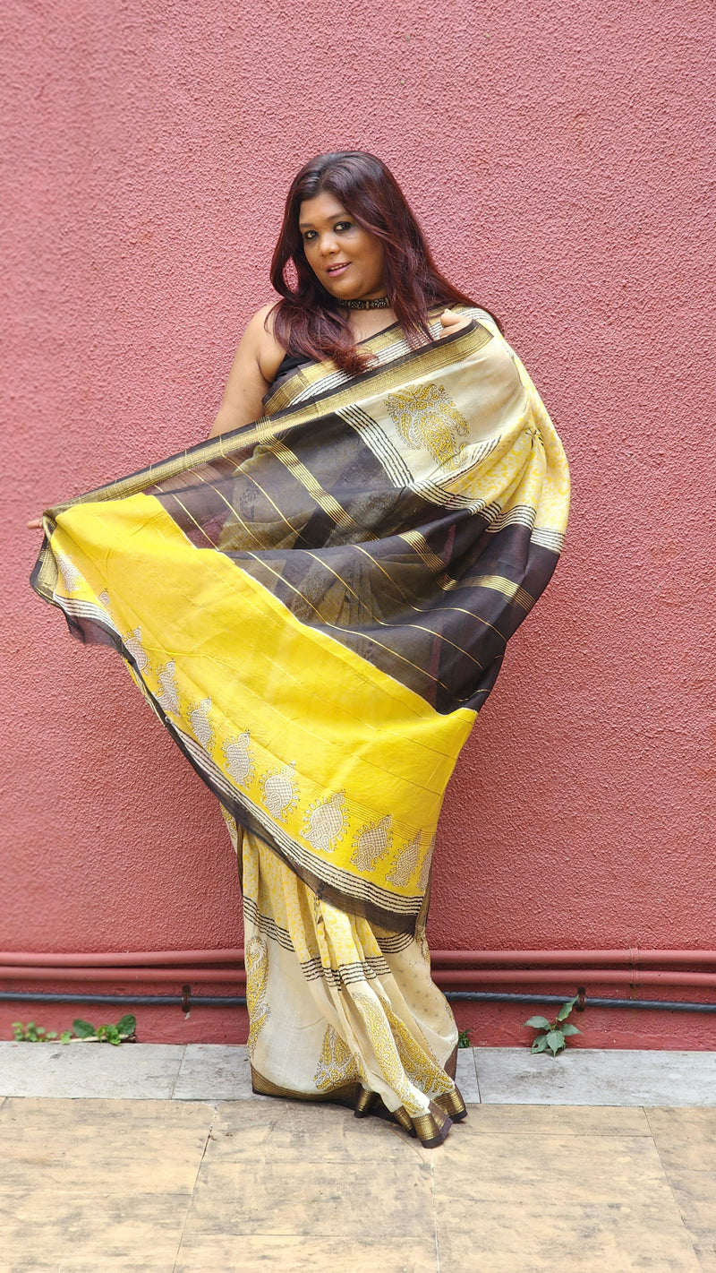 Yellow silk cotton saree with black Bagru handblock stripes, handcrafted and bold, perfect for everyday elegance.
