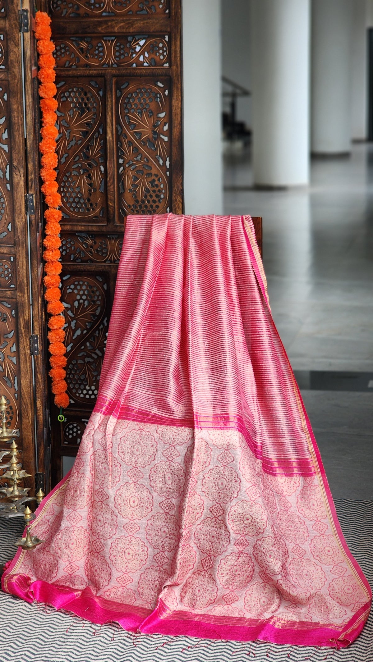 Rose pink matka silk saree with zari border.