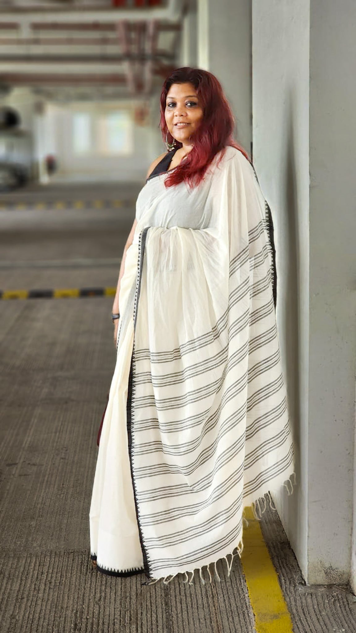 Handloom white saree with bold black border draped for workwear styling